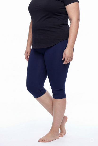 Model wearing SweetLegs Knee-Length Capri in navy blue with black top standing barefoot on white background
