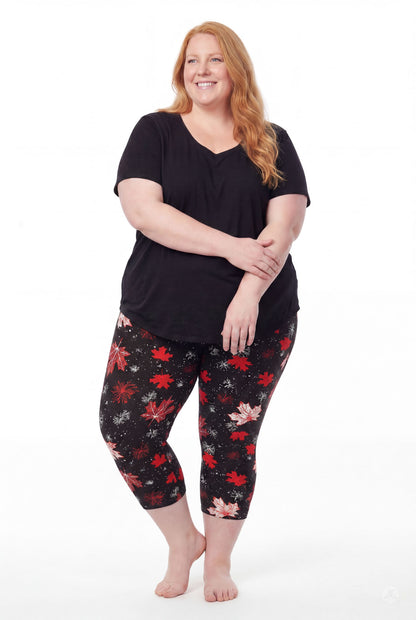 Plus size model wearing SweetLegs Maple Mood Crops with red and white leaf pattern paired with black short sleeve top barefoot