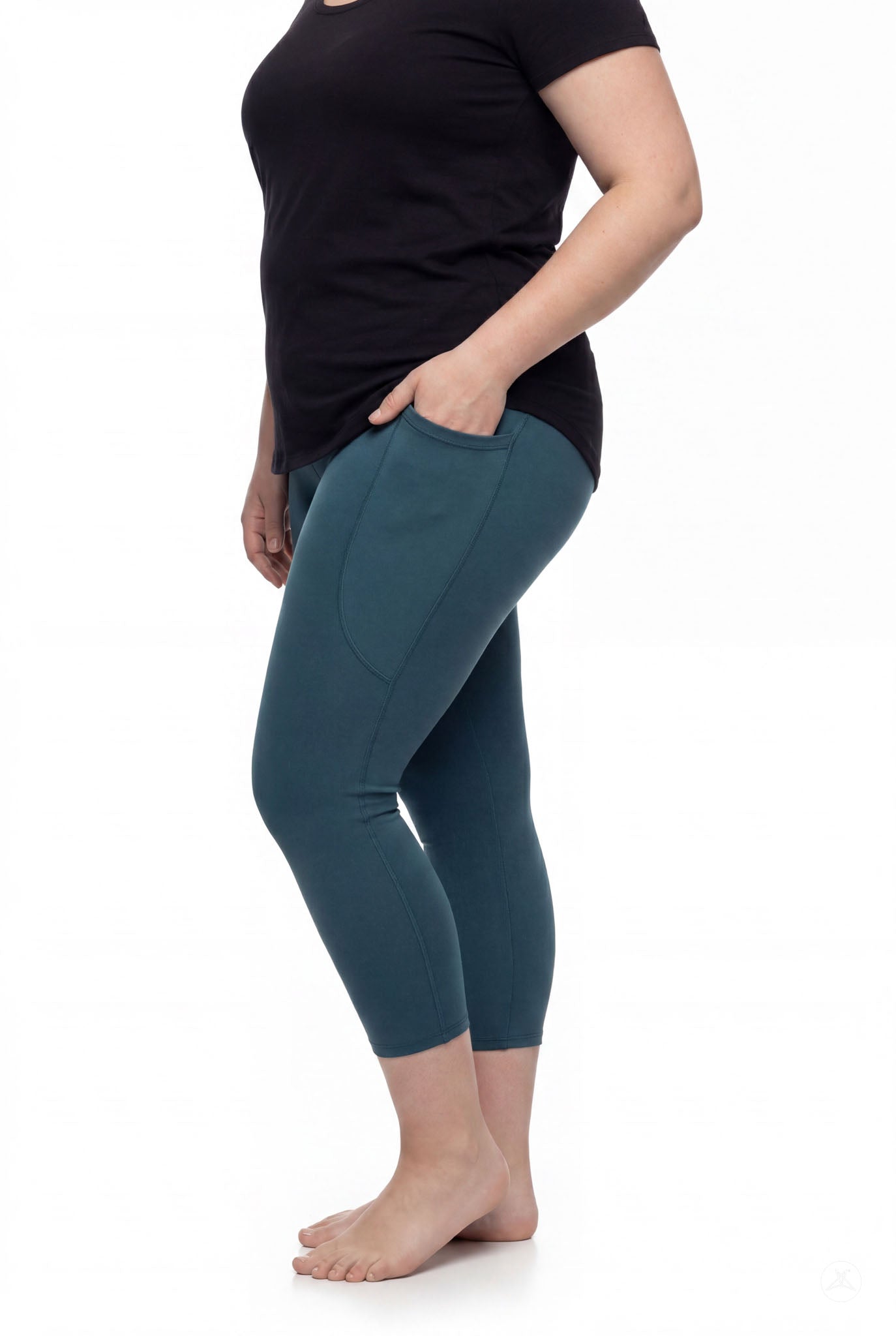 Plus size woman wearing SweetLegs Deep Teal Pocket Crops leggings with side pockets barefoot side view