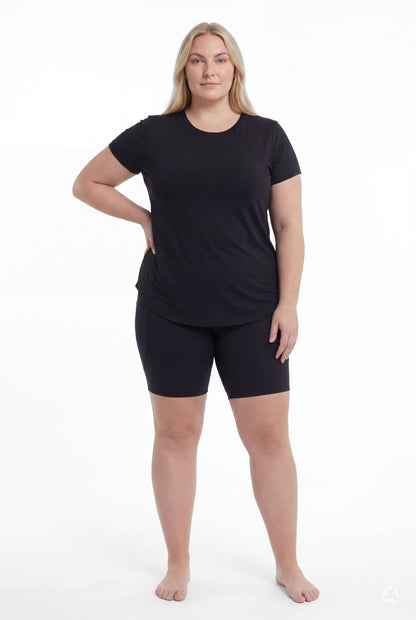 Plus size woman standing barefoot wearing SweetLegs Black Pocket Biker Shorts with black t-shirt front view