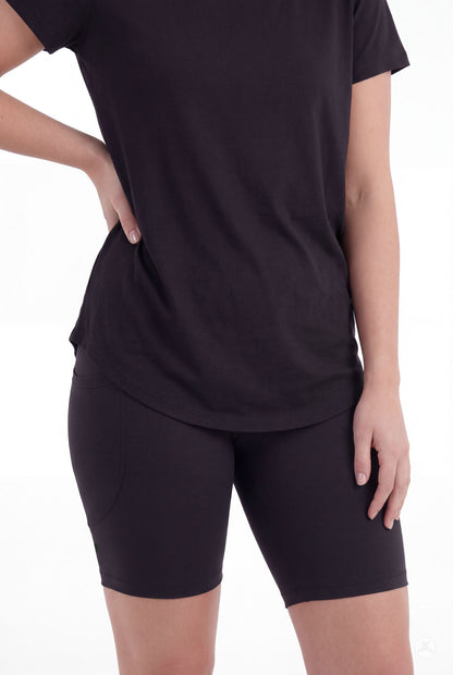 Woman wearing SweetLegs Black Pocket Biker Shorts with black t-shirt standing with hand on hip front view