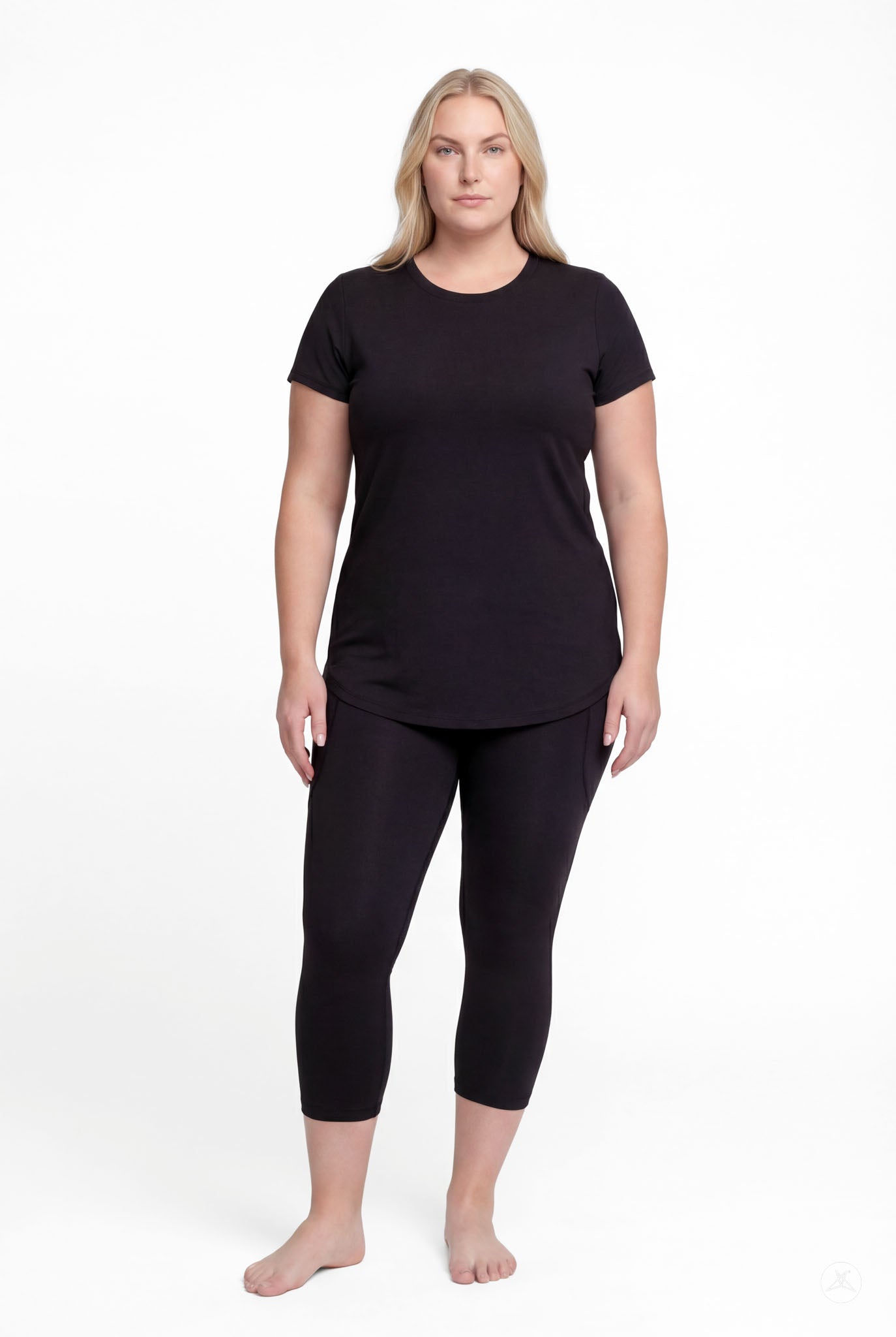 Woman standing barefoot wearing SweetLegs Black Pocket Crops and black short sleeve top facing forward