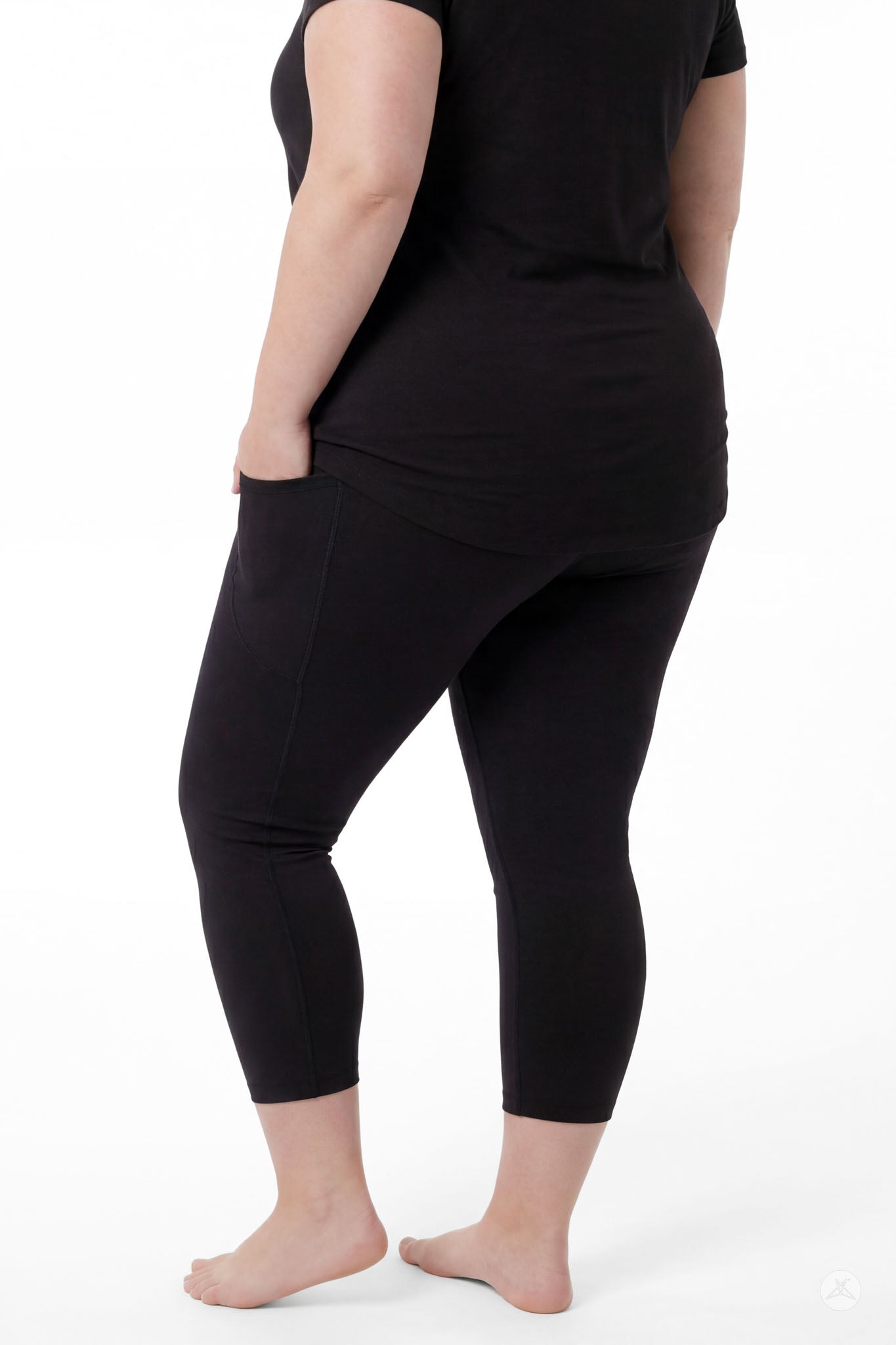 Plus size woman barefoot showing back view wearing SweetLegs Black Pocket Crops with side pockets and black top