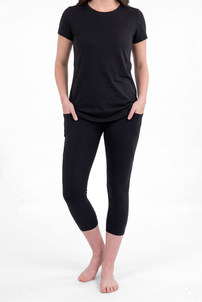Woman wearing SweetLegs Black Pocket Crops with side pockets and black short sleeve top barefoot front view
