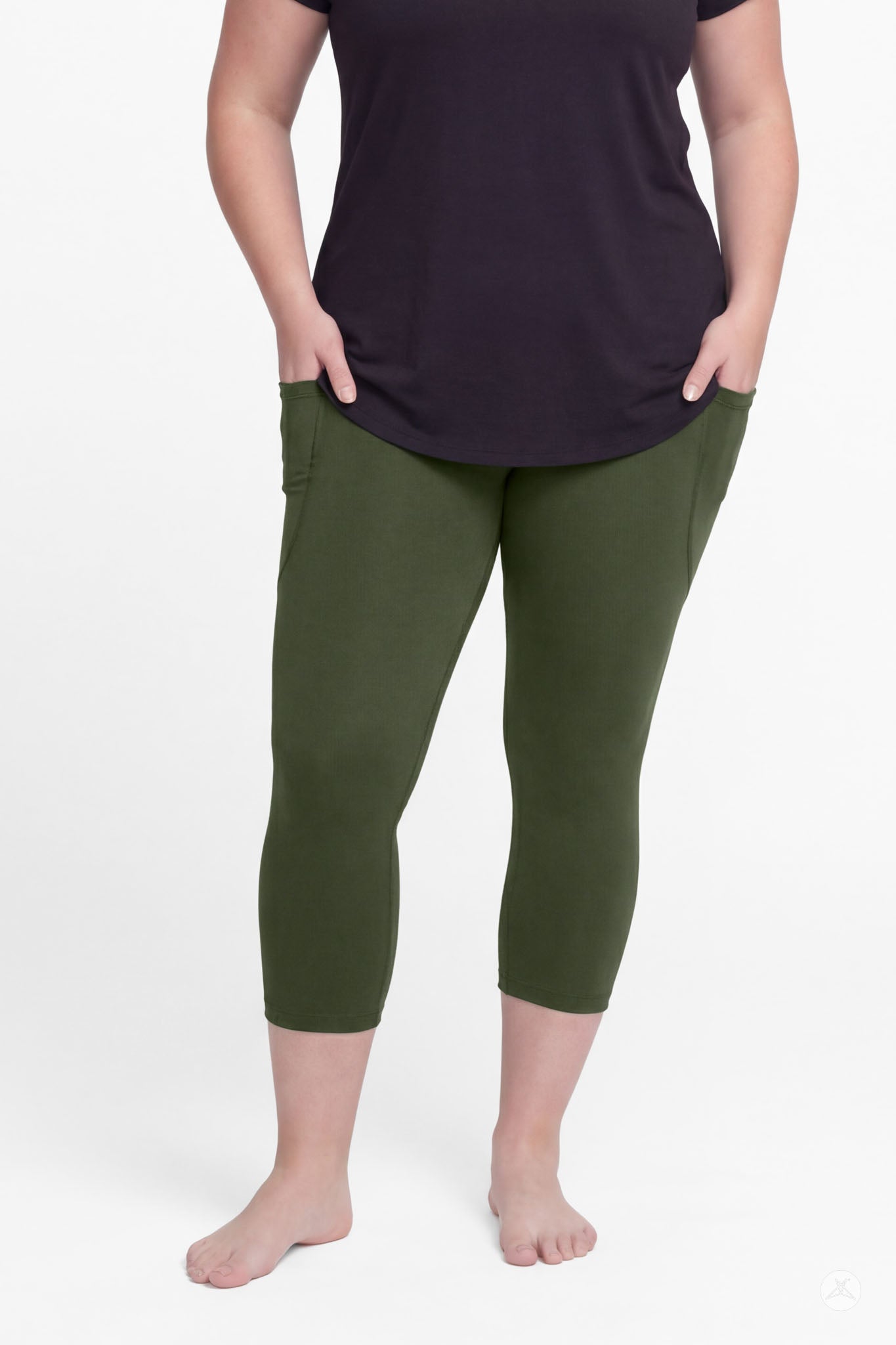 Woman wearing SweetLegs Cedar Pocket Crops in olive green with front pockets and black top barefoot