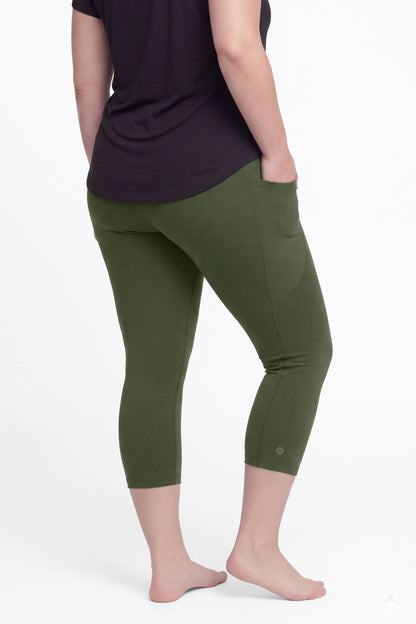 Back view of woman wearing SweetLegs Cedar Pocket Crops in olive green with side pockets and black top barefoot