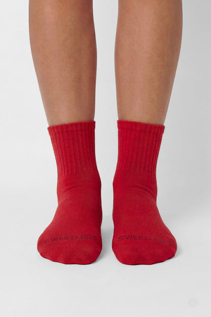 Front view of feet wearing SweetLegs Classic 3-Pack Crew Socks in bright red with ribbed cuffs and seamless toe design
