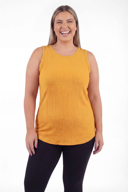 Woman smiling wearing The Soft Ribbed Tank in warm marigold by SweetTops with ribbed texture and sleeveless round neck