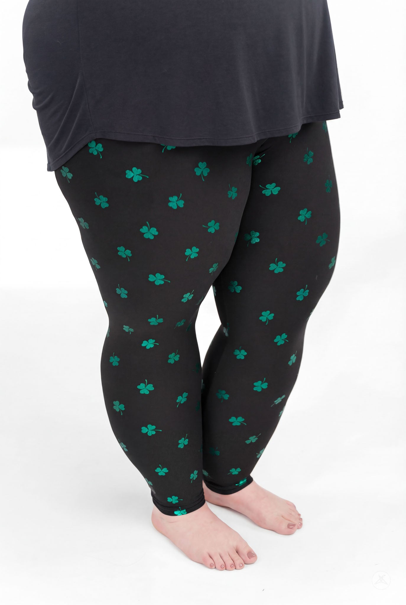 Lucky Glow leggings by SweetLegs featuring emerald foil shamrocks on a deep moody background for a playful look