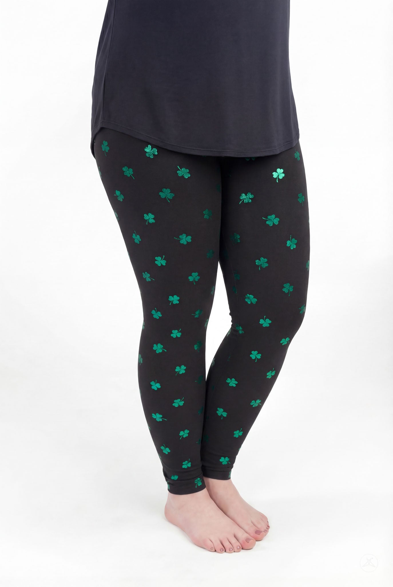 SweetLegs Lucky Glow leggings with scattered emerald shamrock print on black background for stylish comfort