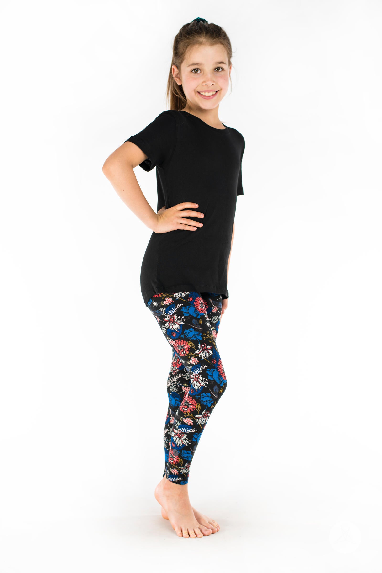Side view of SweetLegs Lovely Day Kids leggings featuring coral-red and persian-blue floral garden print with insects