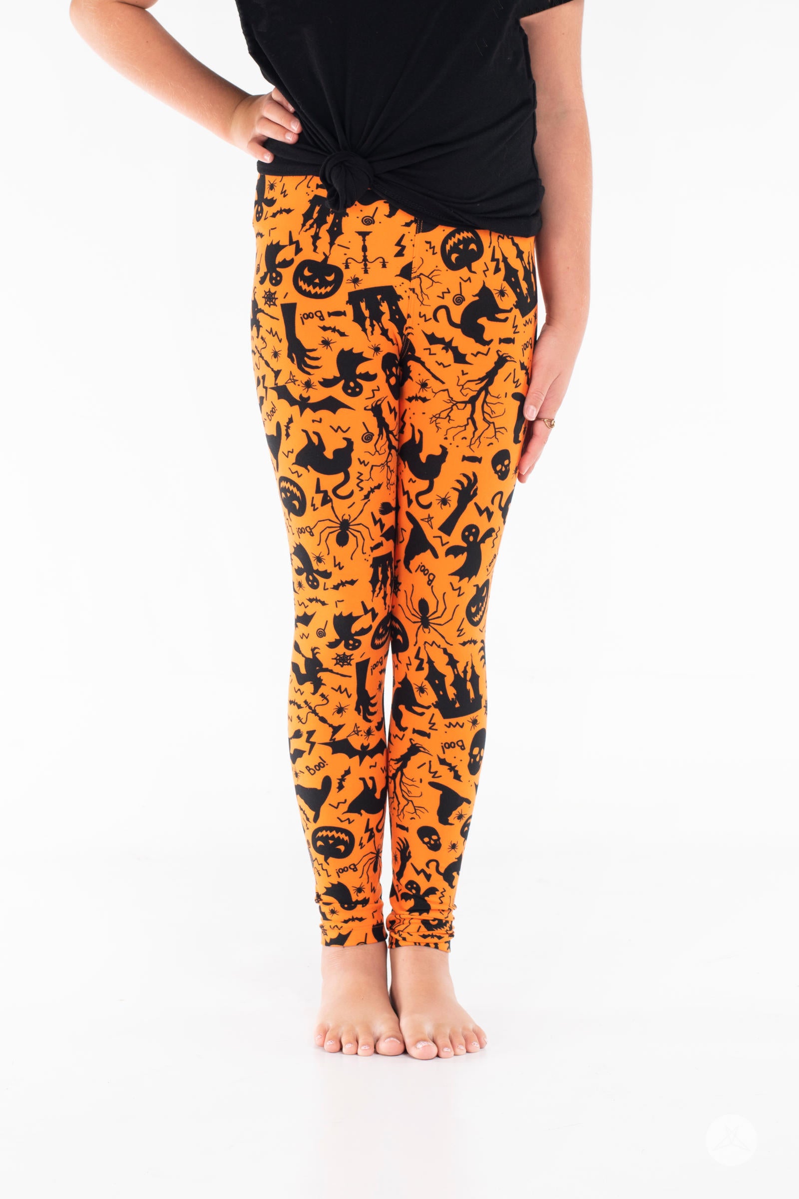 Fa-boo-lous Kids SweetLegs leggings in bright orange with black Halloween bats, pumpkins, cats, skulls, and spider web patterns